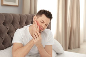 Man in bed with TMJ disorder in Michigan City, IN